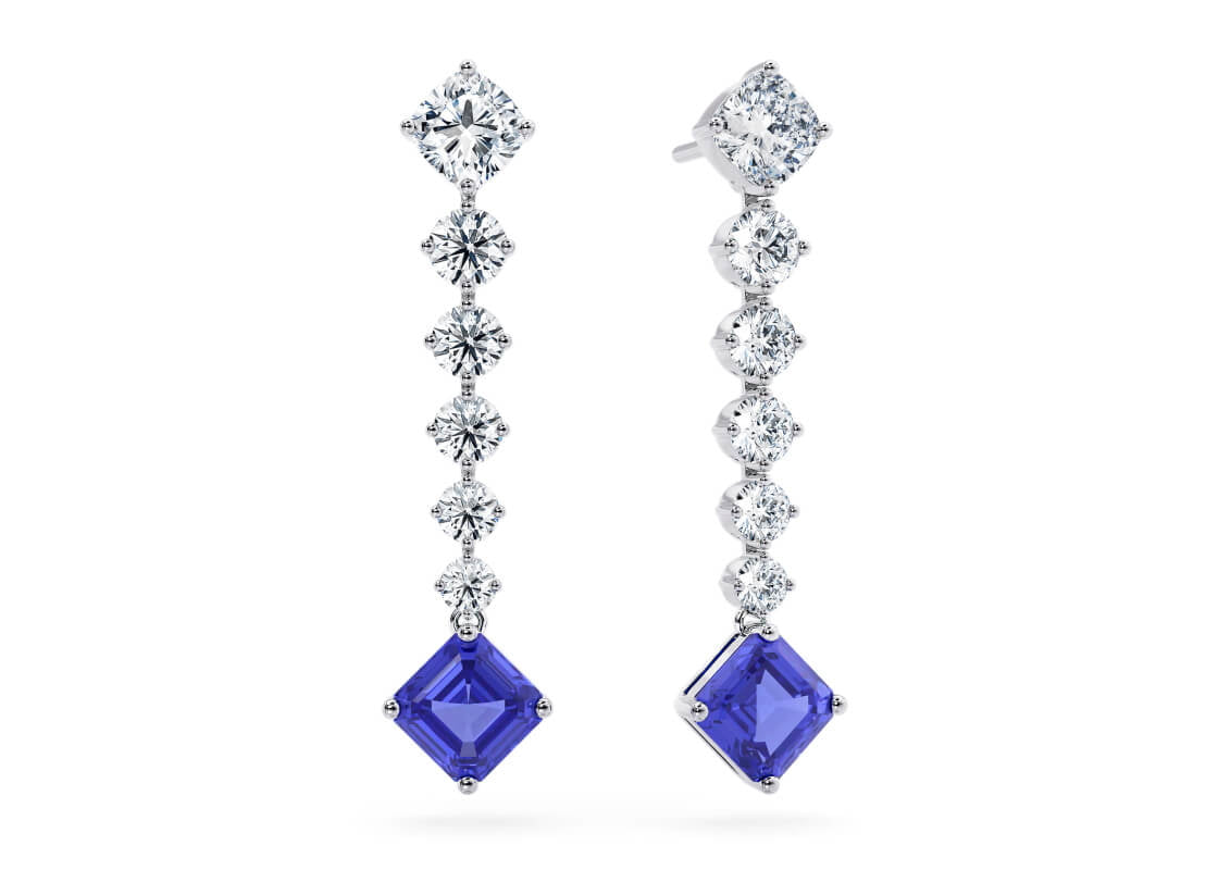 Shine bright with the Celestia linear drop earrings — a dazzling array of diamonds that beautifully showcase a captivating tanzanite gemstone at their heart.