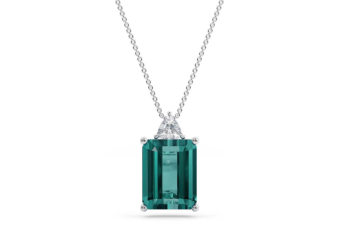 Striking in structure yet soft in sparkle, the Aquarelle Pendant features a vivid centre gem-choose from serene aquamarine or deep teal tourmaline—securely nestled in a refined claw setting. Delicate diamond accents in round, pear, or trillion cuts bring a hint of shimmer, making this piece a sophisticated blend of geometry and elegance.