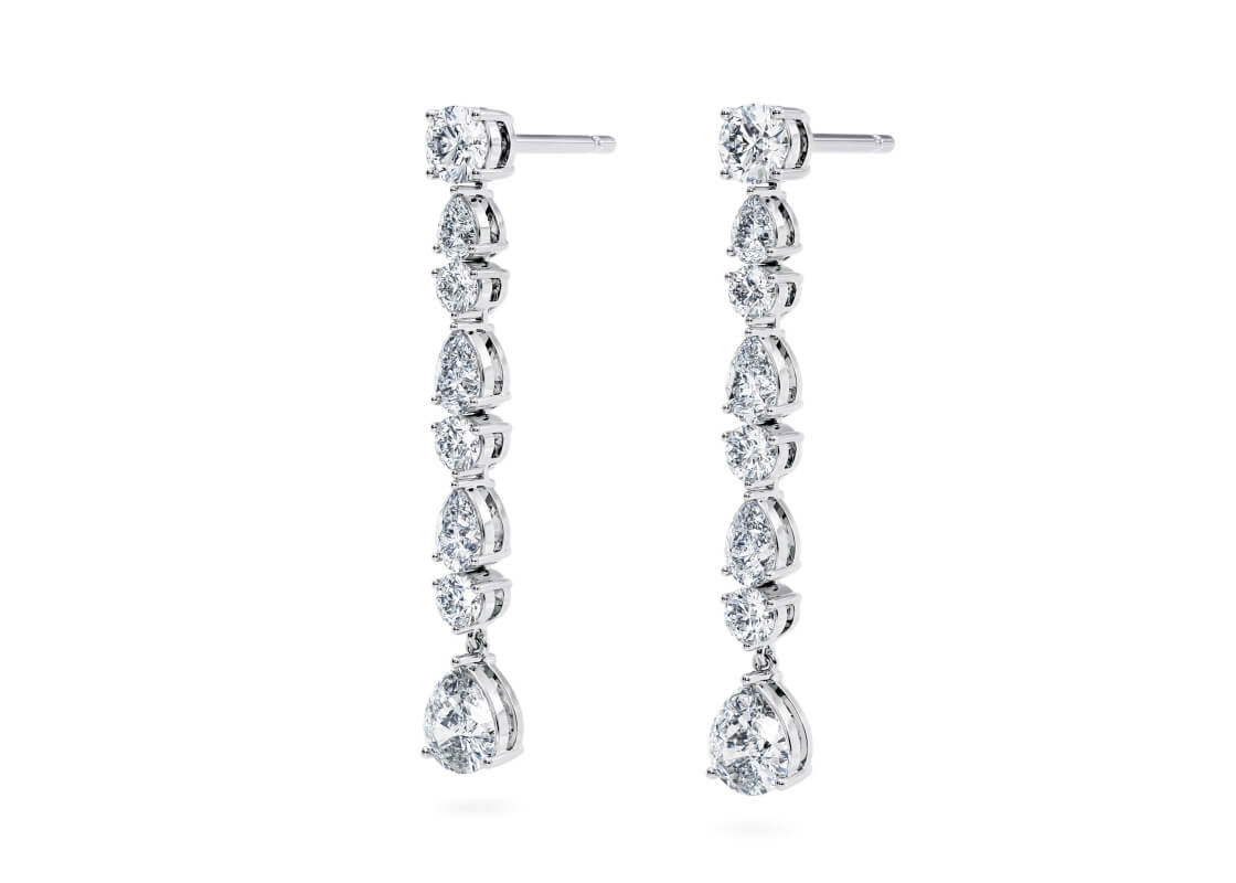 Delicate strands of round and pear-shaped diamonds flow together in these luminous earrings, catching the light with every step. Finished with two pear-shaped diamond drops, they shimmer like water in motion — elegant, fluid, and unforgettable.
