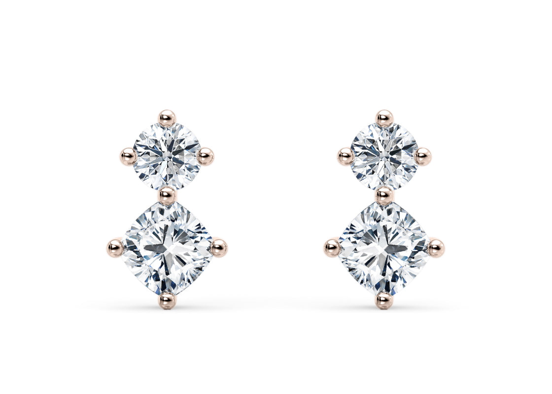 Enjoy a radiant sparkle from every angle with these stunning cushion and round brilliant diamond studs — designed to catch the light and shine endlessly.