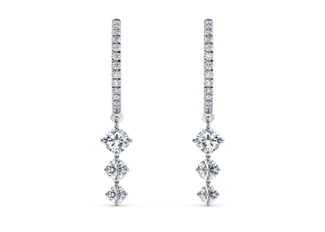 Dance among the stars with the Nova Drops — diamond-studded hoops adorned with three linked diamonds that shimmer with every move, creating a magical, celestial glow.