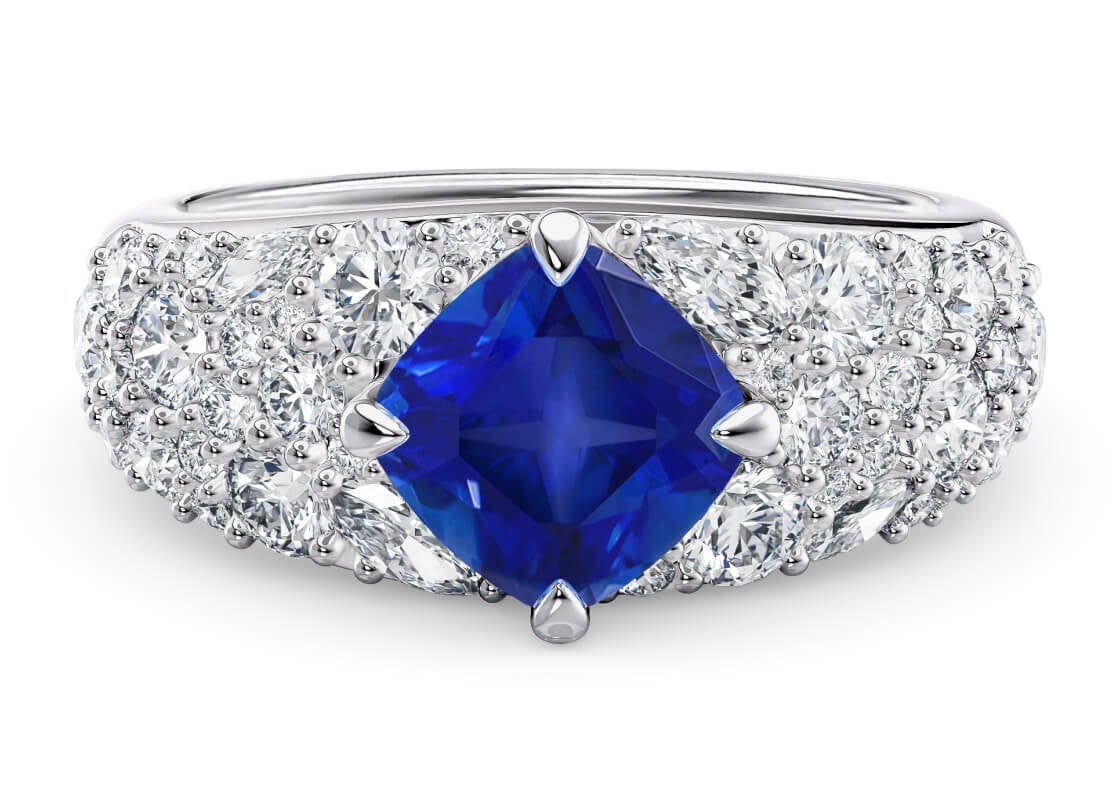 Step into the cosmos with Nebula, where a deep midnight blue sapphire shines like a distant star. Surrounding it, a cluster of round and marquise diamonds sparkle brilliantly, capturing the magic of a star-studded constellation.
