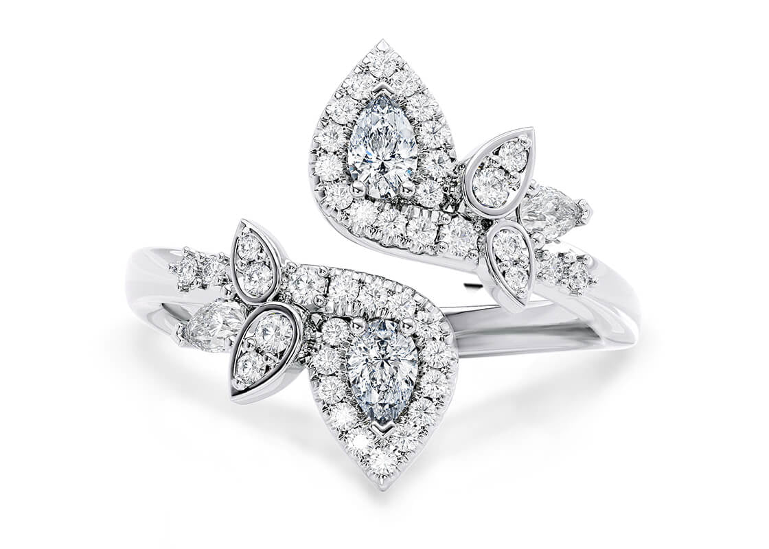 Inspired by the effortless harmony found in nature, this radiant design features two central diamonds poised in opposite directions-symbolizing balance and elegance. Scattered accent stones throughout the piece add depth, sparkle, and a touch of magic to every movement.
