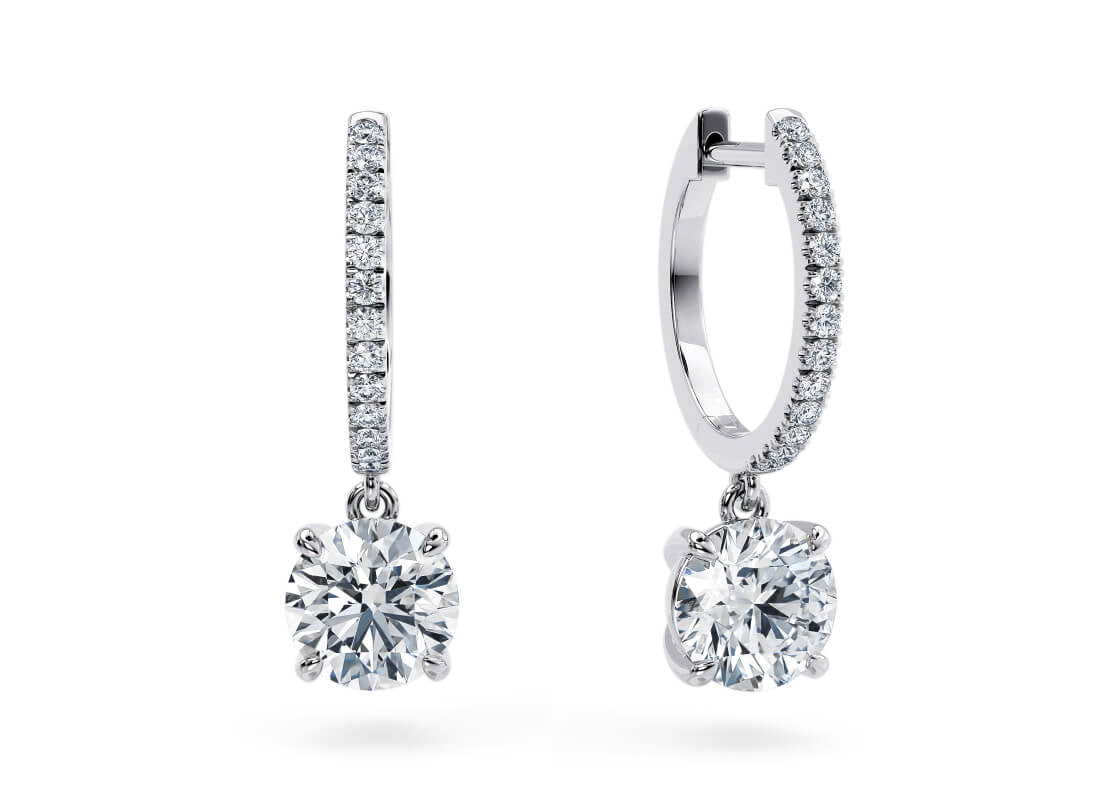 Delicate yet striking, the Elina Drops feature your choice of diamond pendants hanging from two shimmering hoops. Hidden diamonds tucked behind the setting add an extra layer of sparkle, catching the light from every angle.
