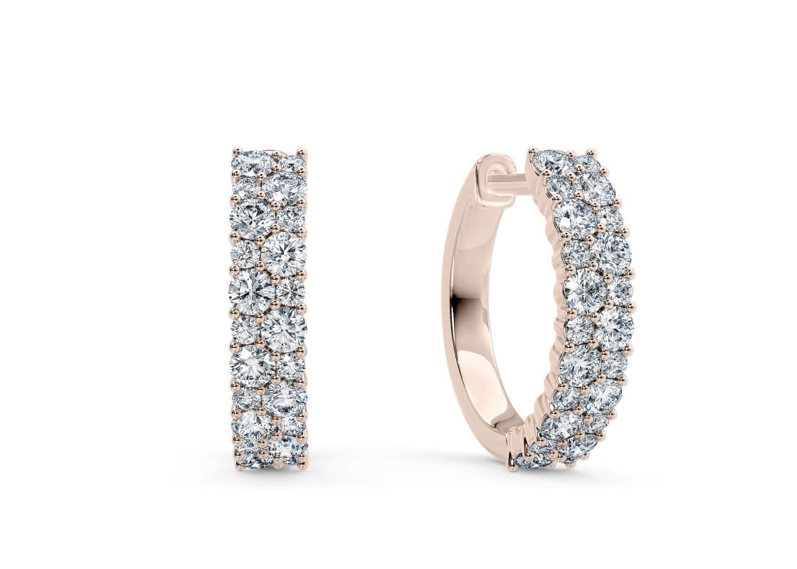 Inspired by our signature design, the Altair Hoops bring brilliance to a classic shape. Featuring a striking arrangement of alternating diamond clusters, they catch the light from every angle - offering a dazzling touch that feels bold yet refined.